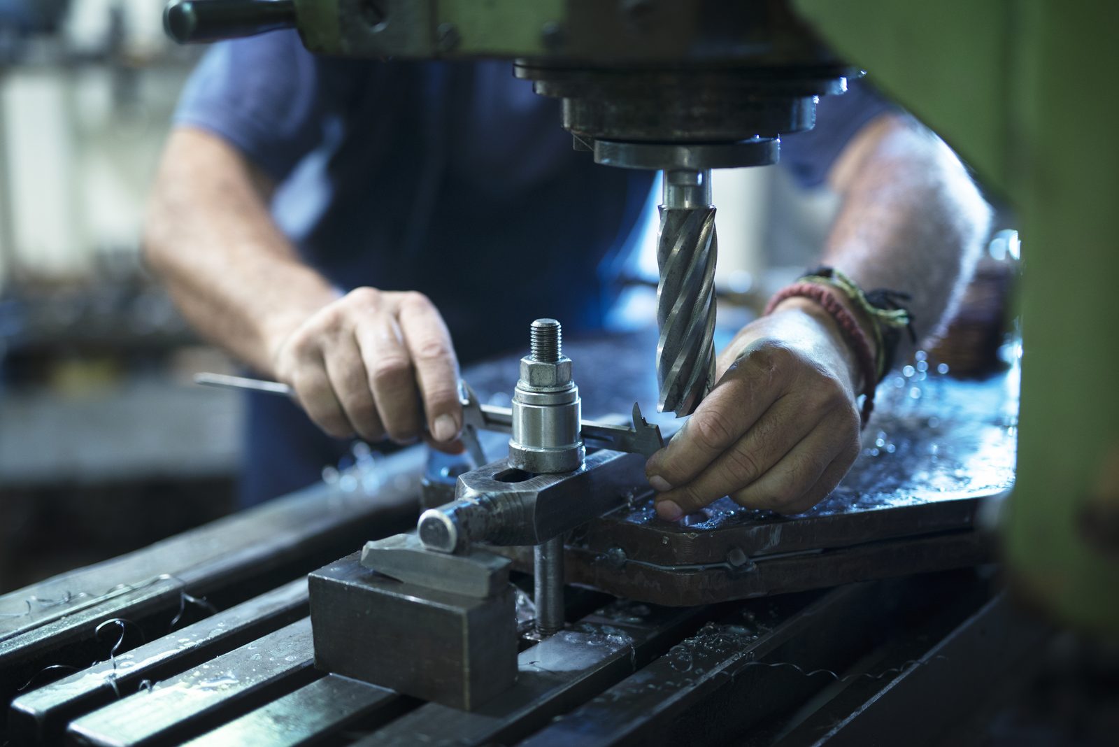 Machinist operating an industrial machine in a metal workshop
